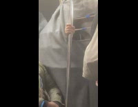 Man in Big Costume Holds on Train Handrail