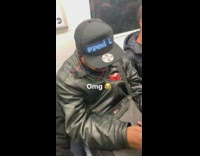 Man wears marquee hat that says Hello I'm Chopped Liver on subway train