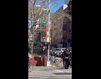 Man hanging does pullups at signal light