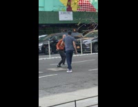 Two men fights at the middle of the street 