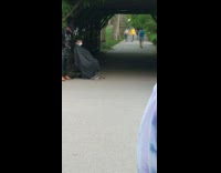 Black hat guy gives haircut at park 