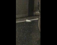 Small plastic bag of cocaine behind mans foot in front of door on subway 