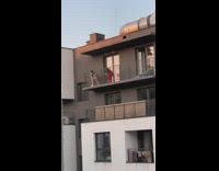 Woman black shorts tiktok twerk balcony building