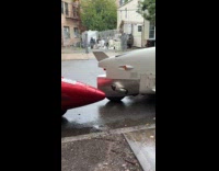 Two aircraft shaped cars parked on street