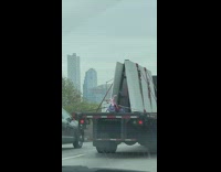 Pink purple Tricycle sits on back of a truck cargo bed