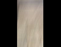 Man in pink thong stands at pay machine machine in subway station