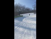 guy rides skis on green bench falls off