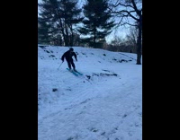 Guy skis at park and does trick 