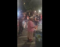 Peaceful protest pink shirt grandma cheers crosswalk 