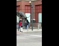 girls under black metal bull statue