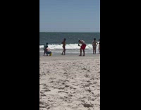 Woman yellow bikini walk on beach bucket