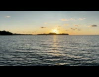 Sun Sets Over Mountain Horizon at Beach