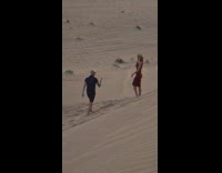 Woman dress fedora hat lay sand dunes
