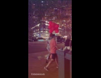 Man Pennywise costume with balloons on street