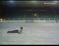 Figure skater slips and falls preparing for jump