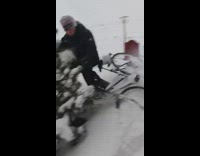 Biker falls into snowy tree 
