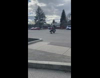 Friend films guy doing wheelie on motorcycle 