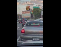 Clown entertains commuters and drivers at middle of the road