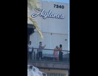 Two girls funny reaction guy phone terrace