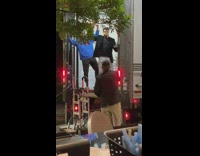 Two men with pizza dances on the back of the truck