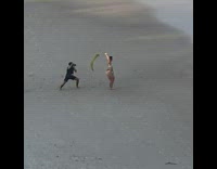 Brunette model holds leaf in bikini for photoshoot