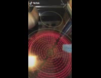 Guy taps blue sponge on electric stove 