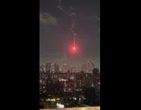 Red flare signal float in the night sky