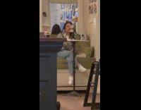 Girl films herself drinking wine at restaurant