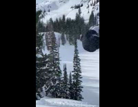 Man Snowboards Downhill and Does Double Front Flip