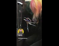 Woman has very long decorated nails on subway train