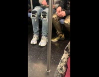 Two guys roll a blunt on subway train after concert