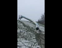 Lady goes down dark slide with her dog 