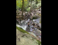 Shirtless guy black pants flex biceps waterfalls