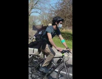 Man Wearing Gold Angel Costume Skateboards 