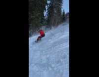 Man risky slide on the  downhill with a snowboard