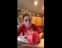 Girl takes bite of whole watermelon 