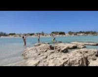 Girl white bikini stand rock guy photobomb