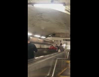 Guy lays back and slides down broken escalator bannister 