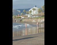 Woman black bikini jump raise arms beach