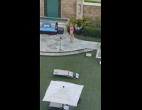 Woman pink strap bikini pose outside couch