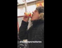 Guy drinks Chef Boyardee can in subway train