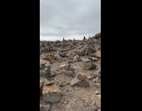 Woman shows cairns built near Morro Rock