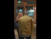 Two people without mask on arguing with restaurant bar owner