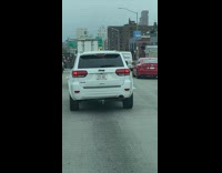 White car with BQE ceo license plate 
