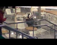 Scream ghost sits alone in subway station cafe