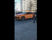 Black shirt guy follows films orange SUV 