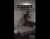 Guy stands bounces on bed claps hands
