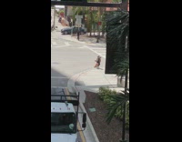 Guy kneel hold speakers dance street intersection