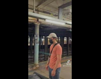 Two guys take black leather couch on subway