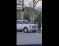 Girl dances on roof of white SUV